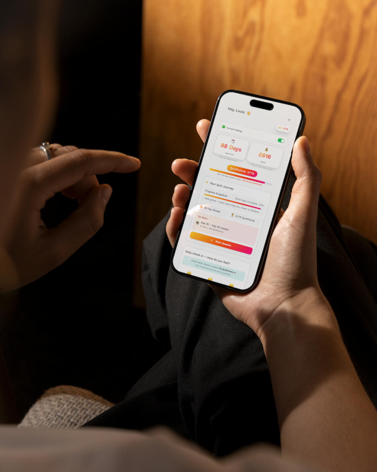 Hands holding a phone with a wellness app